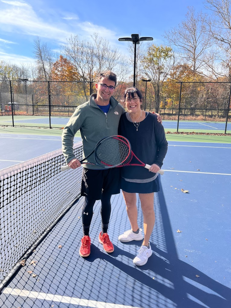 Andreu and an adult player together at the net