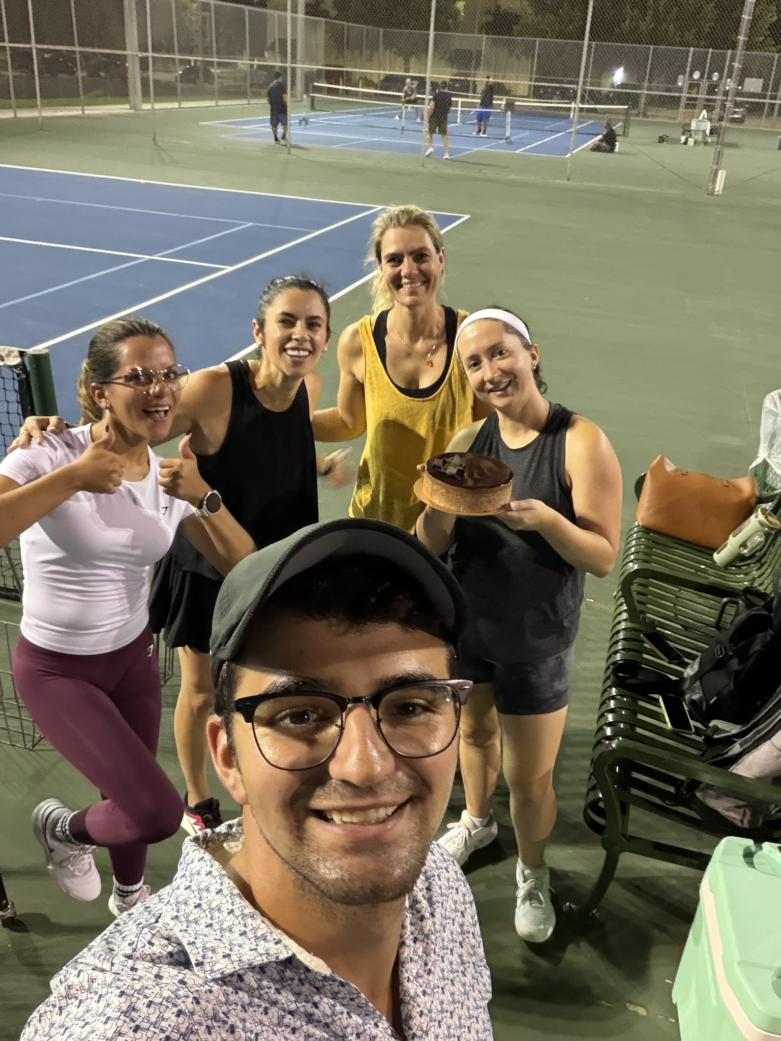 Andreu and adult players smiling after an evening on court