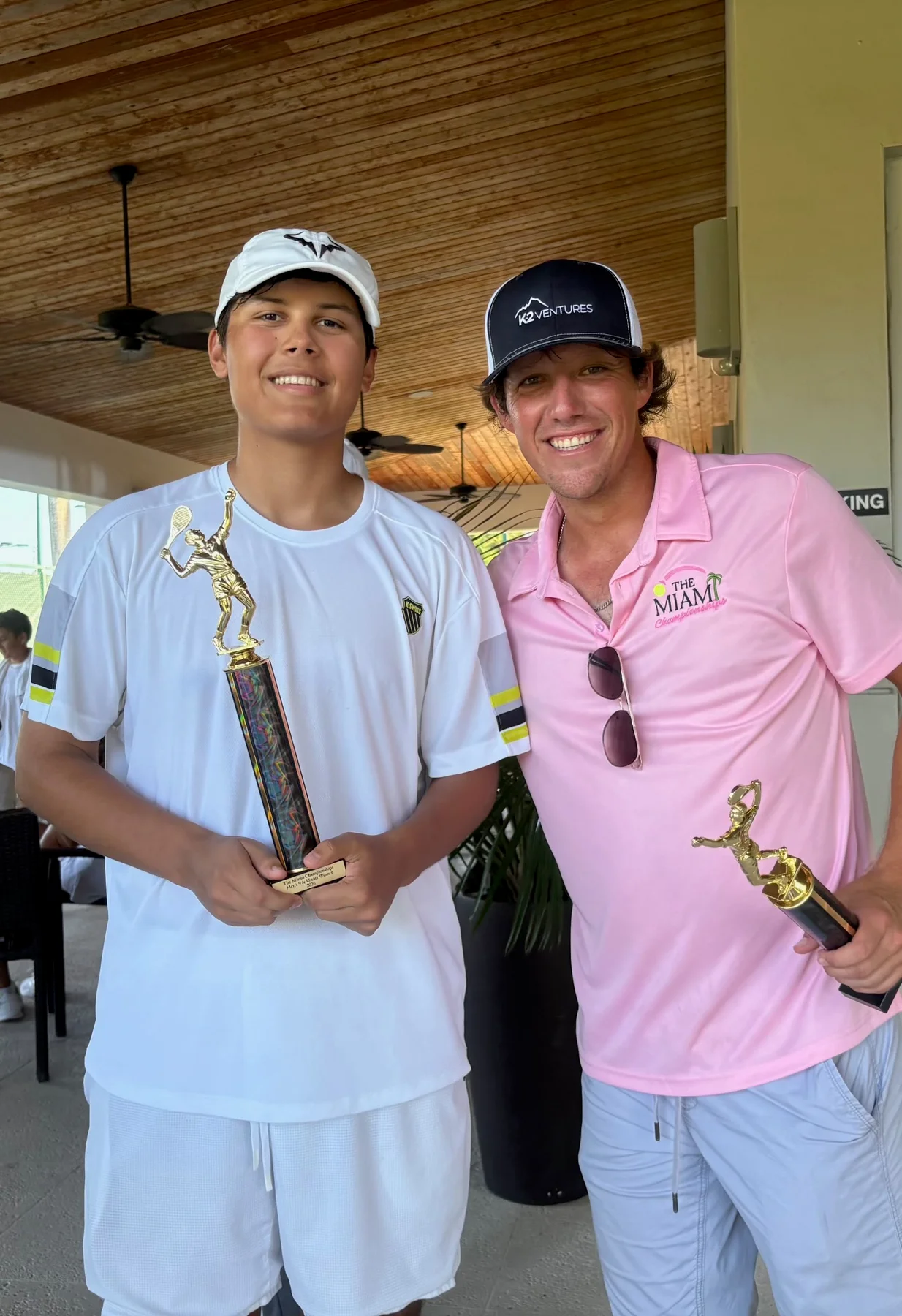 Two tennis players holding their Miami Championships trophies
